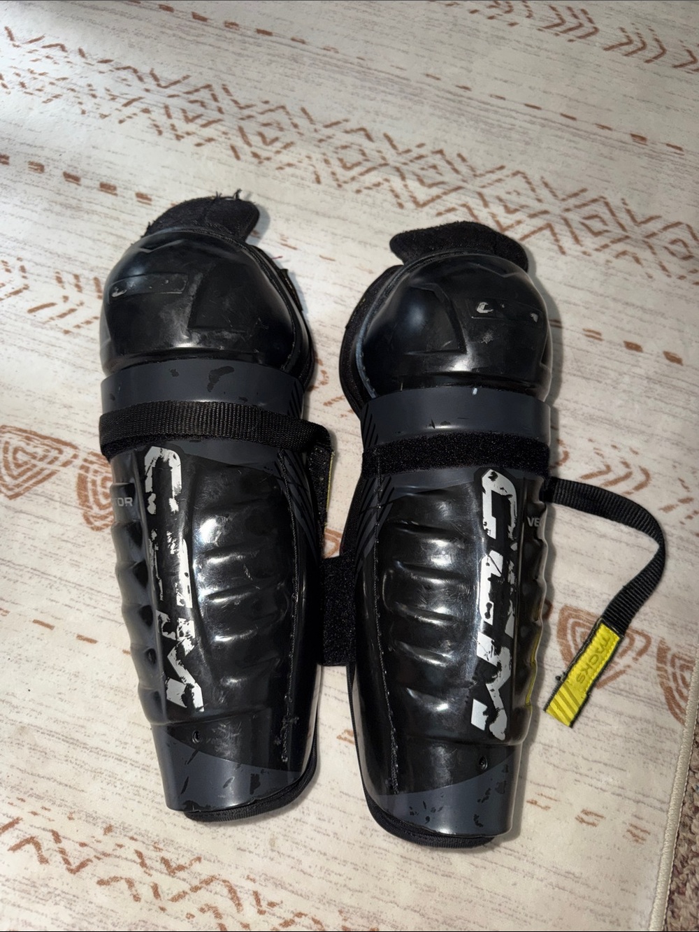 CCM Black Youth Shin Guards with Strap Fastenings